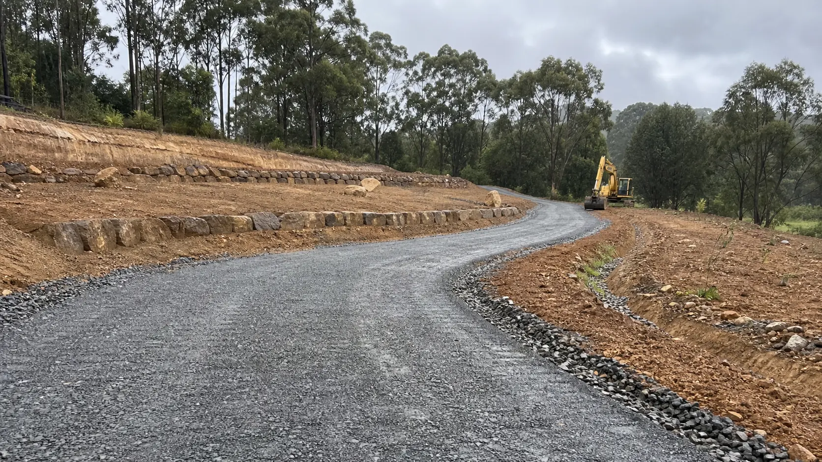 Finished gravel driveway through a landscaped acreage property